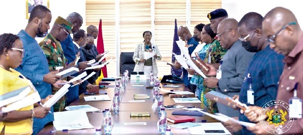 Ursula Owusu-Ekuful (head of table), Minister of Communications and Digitalisation, administering the oath of office to members of the Joint Cybersecurity Committee